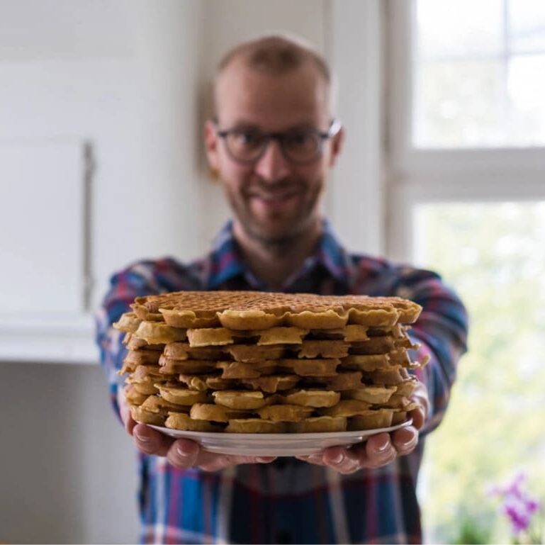Pål handing you a plate full of delicious Norwegian waffles