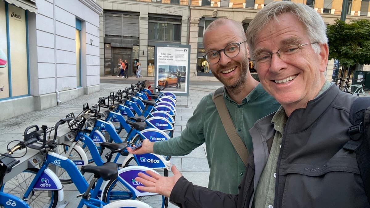 Rick Steves in Oslo next to city bikes