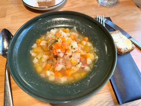 Norwegian meat stew served in a bowl with bread on the side